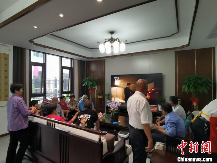 親友們集中在費(fèi)俊龍家中觀看返程的視頻?！＄娚?攝