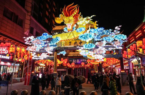 2月11日，游客在沈陽中街游覽。春節(jié)期間，各地?zé)艋痂?、火樹銀花，呈現(xiàn)出一幕幕流光溢彩的視覺盛宴。（新華社記者潘昱龍攝）