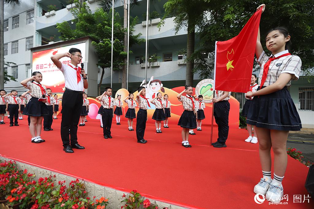 5月31日，在廣西壯族自治區(qū)南寧市民主路小學(xué)，學(xué)校大隊(duì)輔導(dǎo)員帶領(lǐng)少先隊(duì)員呼號。人民網(wǎng)記者 嚴(yán)立政攝