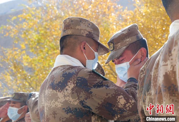 圖為什布奇邊防連退伍老兵與戰(zhàn)友相擁而泣，依依惜別?！⌒觳?攝