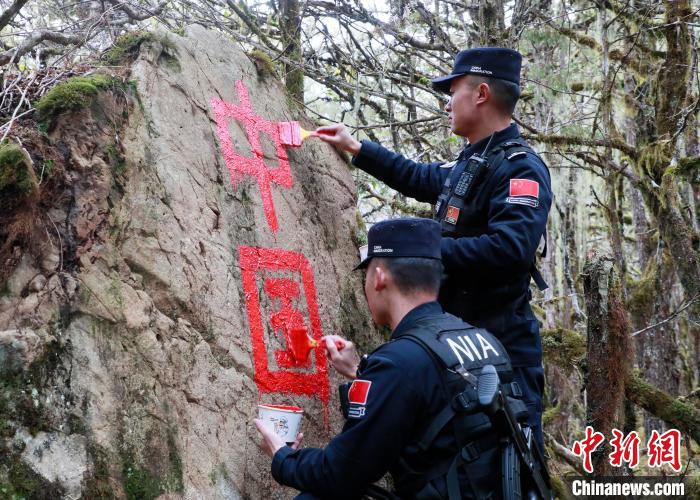山南邊境管理支隊(duì)玉麥邊境派出所民警邊境巡邏途中在石頭上用油漆涂寫(xiě)“中國(guó)”二字 。　鄭琦山 攝